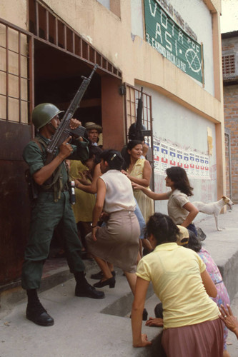 Soldiers guarding a polling place entrance, San Salvador, El Salvador, 1982