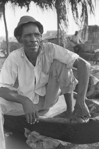 Man sitting at city market, Cartagena Province, ca. 1978