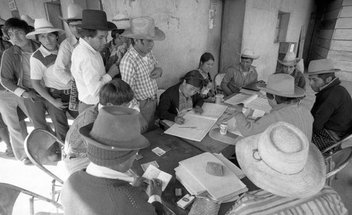 Men voting on election day, Guatemala City, 1982