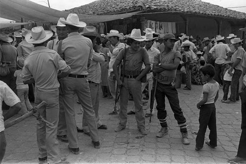 Boy looking at guerrillero near Corinto, Morazán, 1983