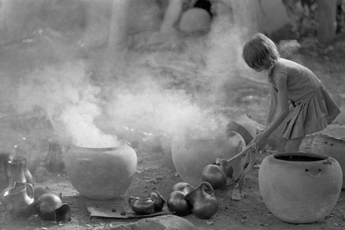 Girl with smoking clay jugs, La Chamba, Colombia, 1975