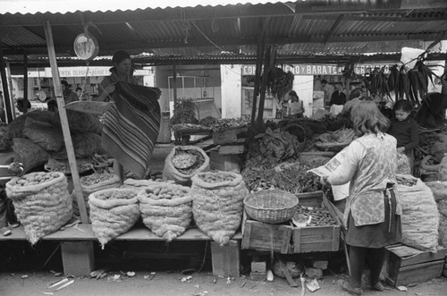 A fruit and vegetable stand at a market, Tunjuelito, Colombia, 1977