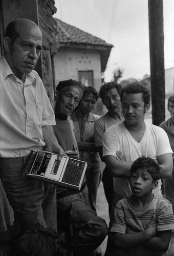 Man with a cassette player surrounded by people, Nicaragua, 1979