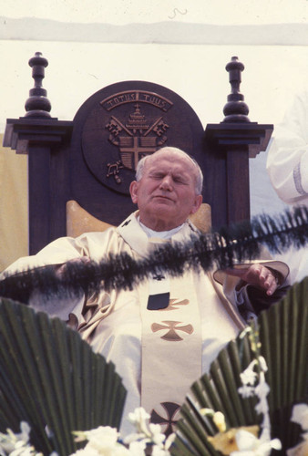 Pope John Paul II sitting in a large wooden chair, Tegucigalpa, Honduras, 1983