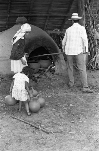 Man operating an oven, La Chamba, Colombia, 1975