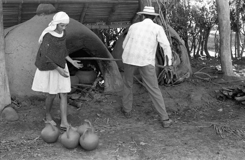 Man operating an oven, La Chamba, Colombia, 1975