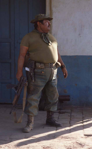 Colonel Jaime Flores Grijalva standing in the street, San Agustín, 1983