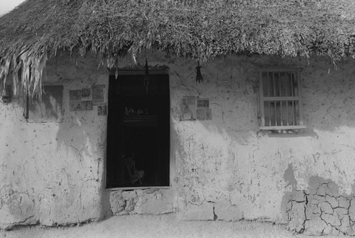 Newspaper clippings hanging from exterior wall, San Basilio de Palenque, 1976