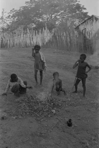 Children playing with a small fire in the street, San Basilio de Palenque, ca. 1978