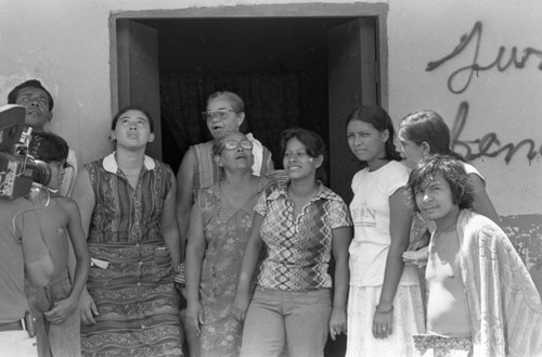 People and cameraman outside doorway, Nicaragua, 1979