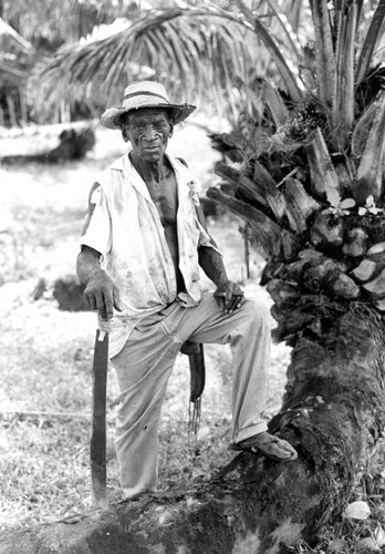 Man standing next to a tree, San Basilio de Palenque, 1976