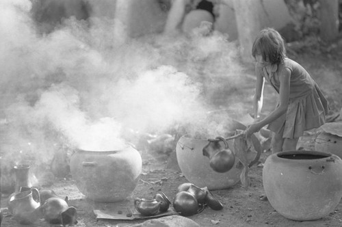 Girl with smoking clay jugs, La Chamba, Colombia, 1975