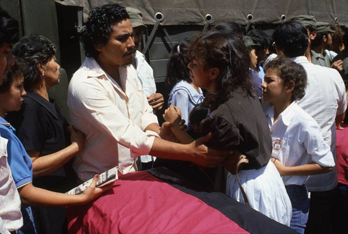 Young woman cries next to a coffin, Nicaragua, 1983