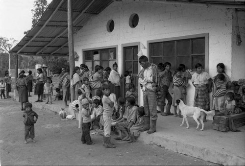 Refugees wait outside a clinic building, Chiapas, 1983