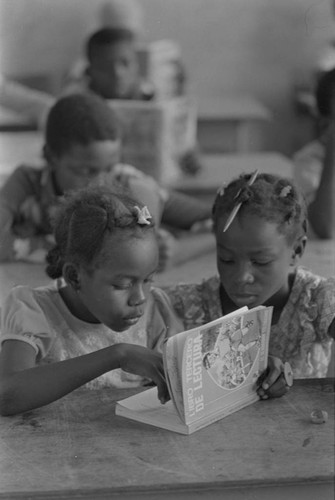 Students in a classroom reading a book, San Basilio de Palenque, ca. 1978