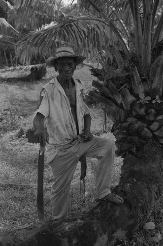 Man standing next to a palm tree, San Basilio de Palenque, 1976