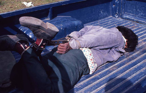 Hogtied man in a pickup truck bed, Guatemala, 1982