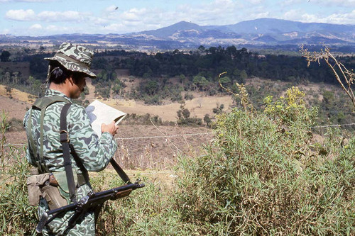 An armed soldier looks at a map, Zaragoza, 1982