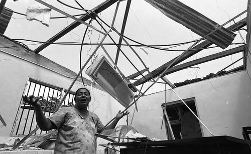 Woman in destroyed home, Nicaragua, 1979