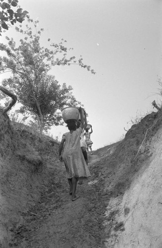 Girls carrying water uphill, San Basilio de Palenque, Colombia, 1977