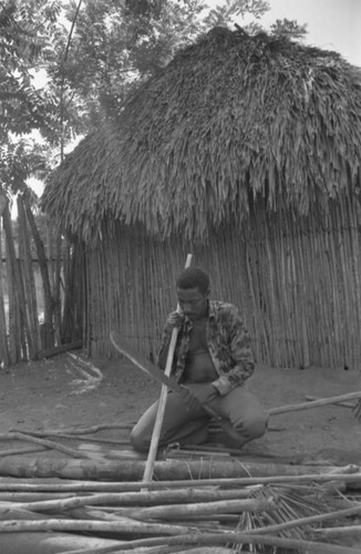 Man smoothing wood, San Basilio de Palenque, 1977