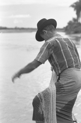 Fisherman holding a net, La Chamba, Colombia, 1975