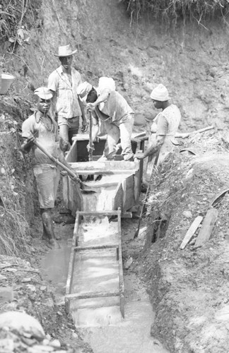 Three men and a women at work, Barbacoas, Colombia, 1979