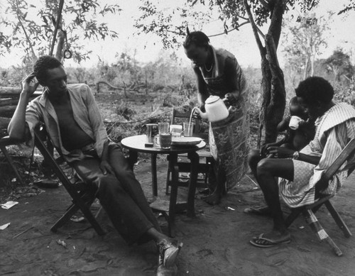 Villagers dining outdoors, Tanzania, 1979