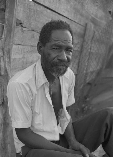 Man sitting at city market, Cartagena Province, ca. 1978