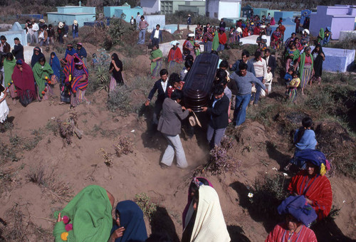 Men carrying a coffin at a cemetery, Patzún, 1982