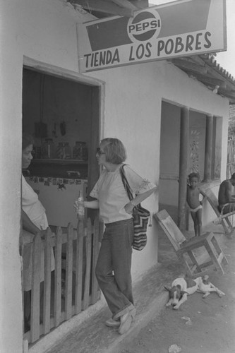 Nina S. de Friedemann and woman talking at doorway, San Basilio de Palenque, ca. 1978