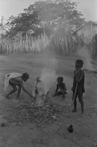 Children playing with a small fire in the street, San Basilio de Palenque, ca. 1978