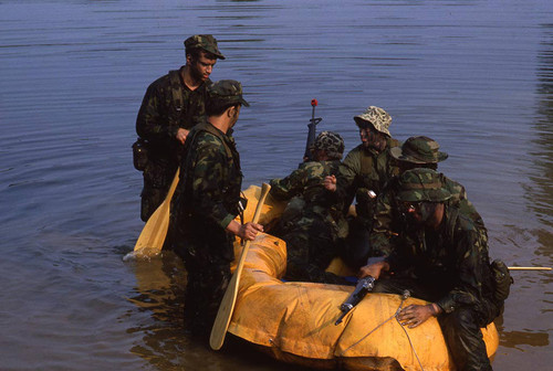 Survival school students stand near a raft, Liberal, 1982