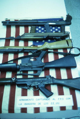 Captured weapons cache and a U.S. flag, Nicaragua, 1983