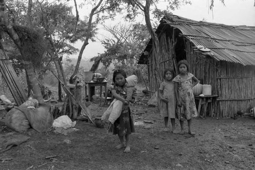 Refugee girls outside of a hut, Chiapas, 1983