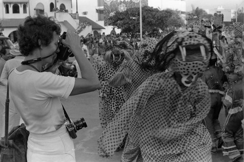 Women photographing dancers, Barranquilla, Colombia, 1977