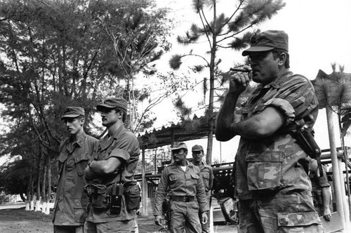 U.S. military advisor smokes at military air base, Ilopango, 1983