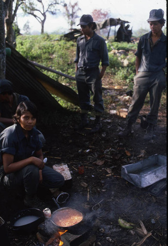 A female Contra soldier cooks for the camp, Nicaragua, 1983