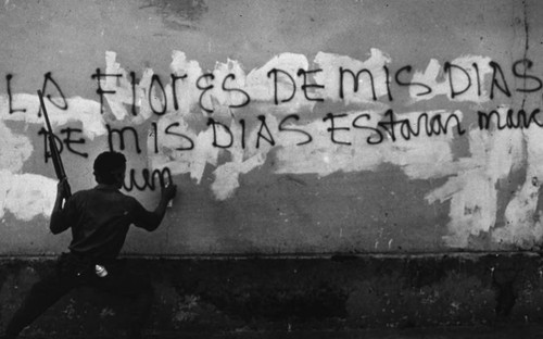 Sandinista spray paints on a wall, Nicaragua, 1979