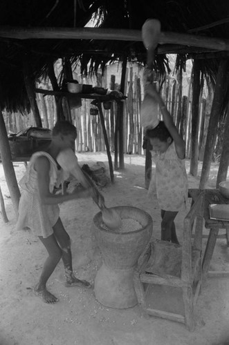 Girls pounding grain in a mortar, San Basilio de Palenque, 1976