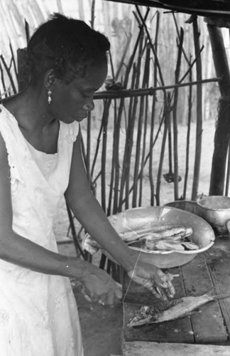 Woman cleaning fish, San Basilio de Palenque, 1975