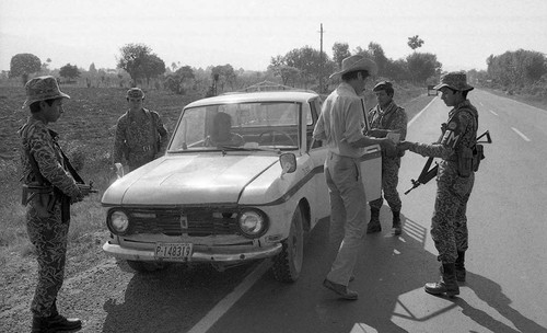 Soldiers surround pick up truck at a checkpoint, Guatemala, 1982