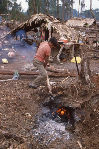 A Guatemalan refugee stokes a fire, Chajul, ca. 1983