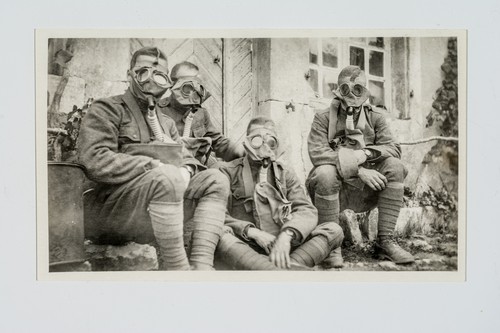 Four Soldiers Wearing Gas Masks