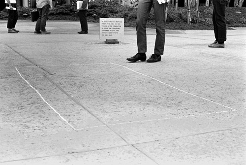 Body Bags: chalk marks indicating original location of censored sculpture