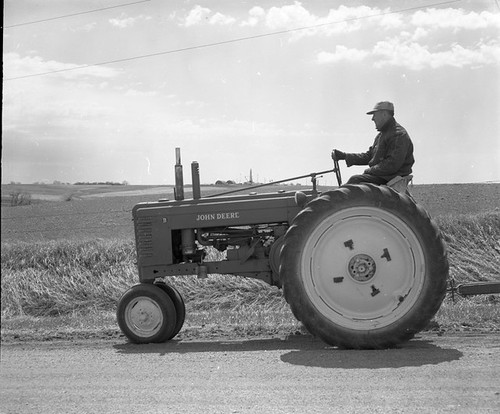 Atlas 551-9: Farmer Driving Tractor Down Road with Missile Site in Background; Looking South. Date: 04/17/1962