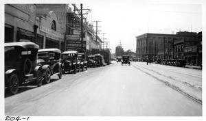 Construction material piled in front of Lord Motor Car Company Building on east side of Figueroa Street just north of Pico, Los Angeles, 1923