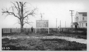 Looking easterly into corner desired for highway purposes. Men are standing on curb line of plan proposed by City of El Monte. Proposed easement from P.E. Ry. for connection of El Monte Blvd., and Columbia Street, El Monte, Los Angeles County., 1927