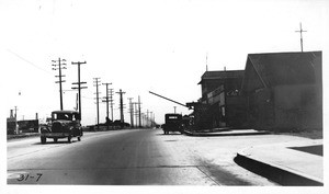 Looking south on west roadway, Vermont Avenue at 119th Place showing real estate sign in parking