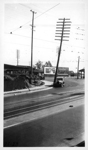 Looking easterly showing leaning pole at northwest corner of 7th and Boyle Avenue, Los Angeles, 1928